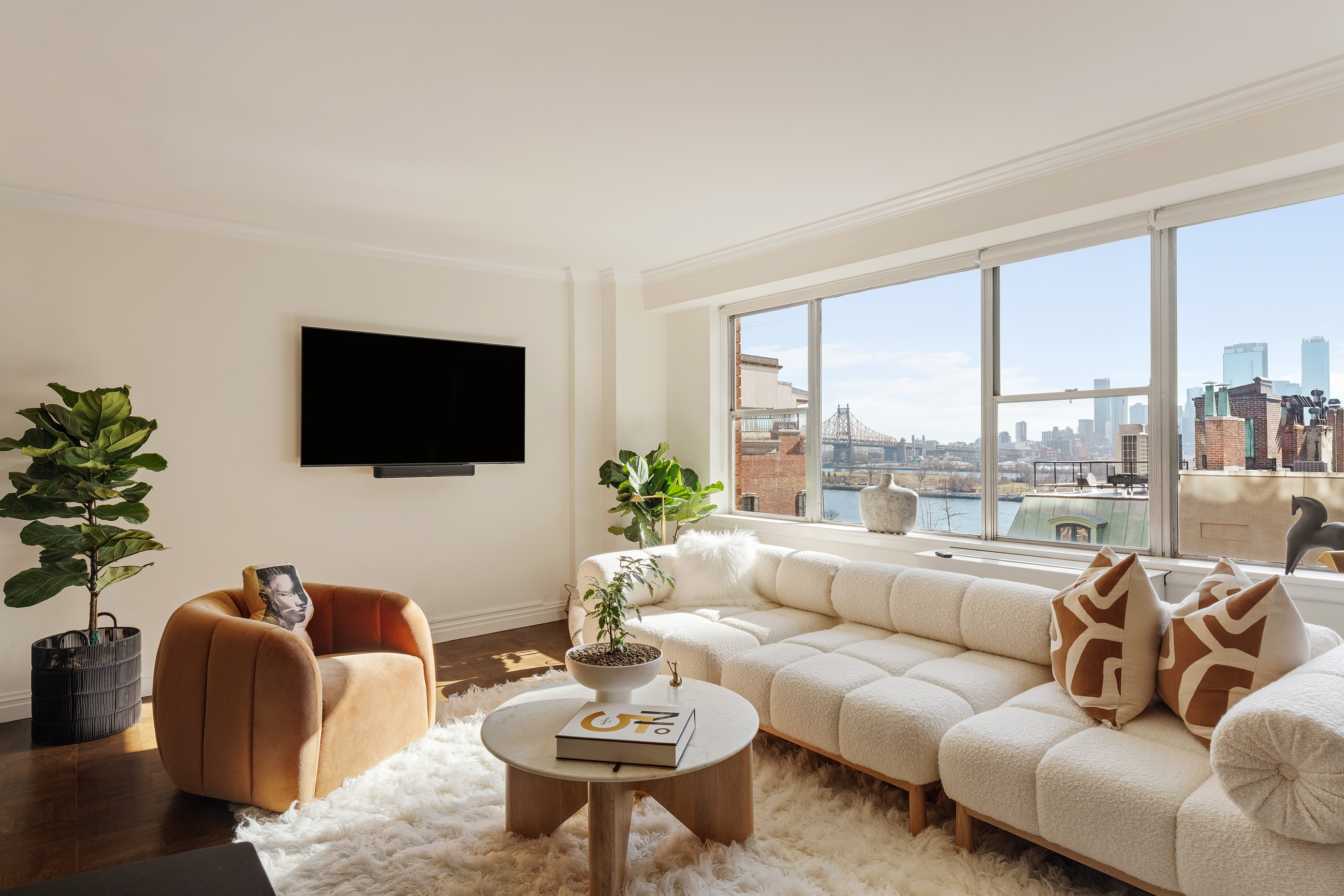 12 Beekman Place, Unit 7/8B Manhattan, NY 10022 - Photo 1 of 17 a living room with furniture a flat screen tv and a floor to ceiling window
