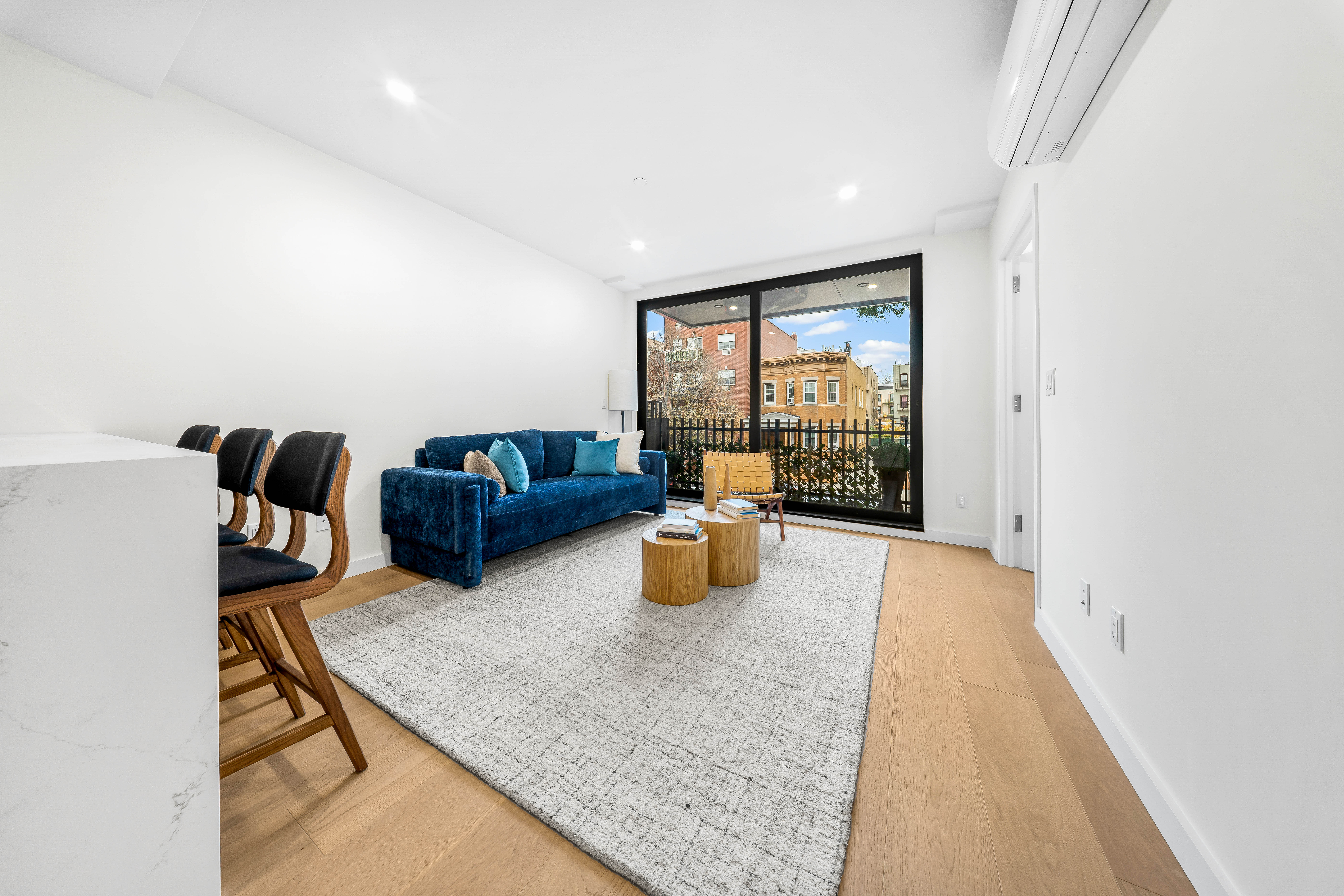 30-24 32nd Street, Unit 3A Queens, NY 11102 - Photo 9 of 18 a living room with furniture and wooden floor