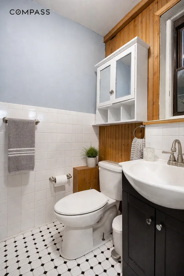 a bathroom with a sink a toilet and a mirror