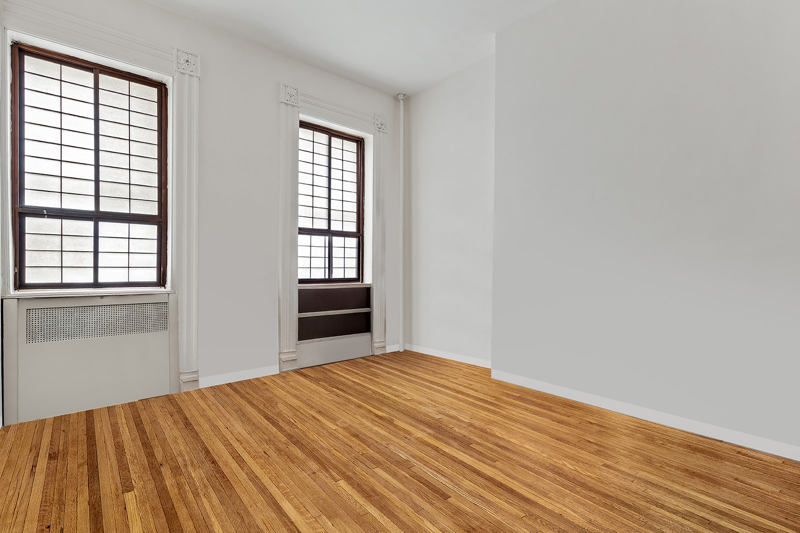 198 6th Avenue Manhattan, NY 10013 - Photo 22 of 45 an empty room with wooden floor and windows