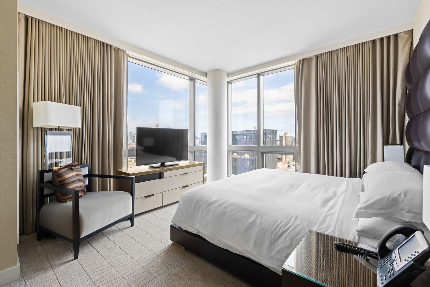 246 Spring Street, Unit 2910 Manhattan, NY 10013 - Photo 8 of 17 a bedroom with a bed and large windows