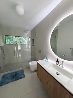 a bathroom with a double vanity sink toilet and a mirror