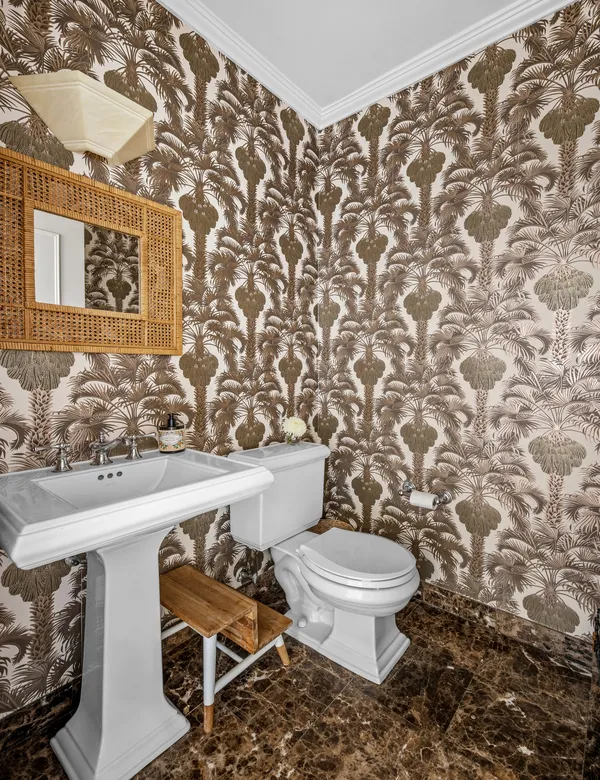 a white toilet sitting next to a shower curtain