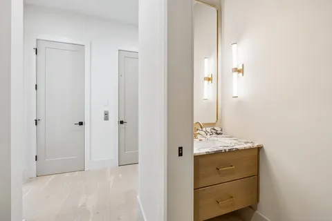 an empty room with windows and mirror