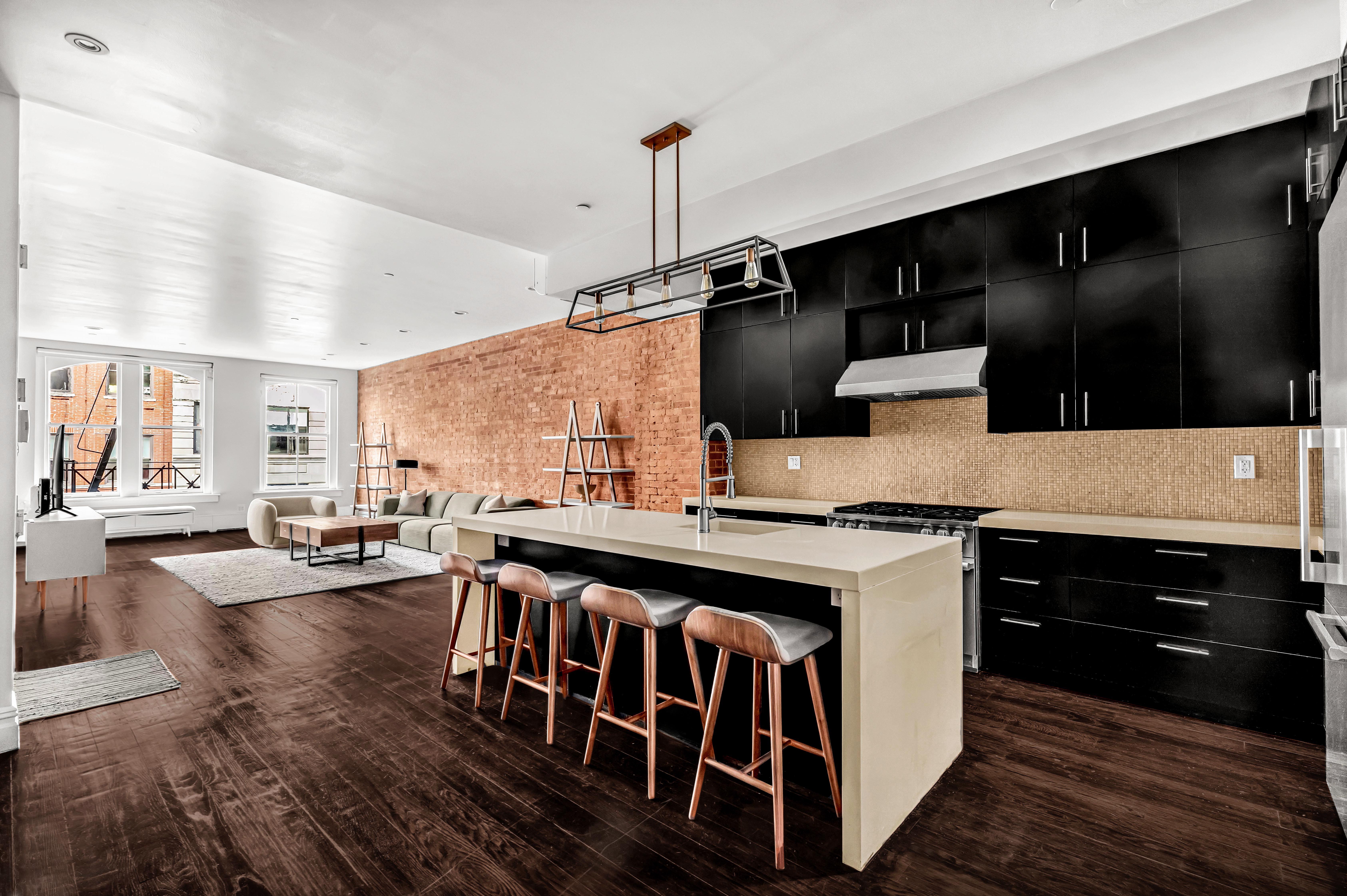 175 Franklin Street, Unit 4 Manhattan, NY 10013 - Photo 12 of 13 a kitchen with kitchen island a stove and a wooden floor