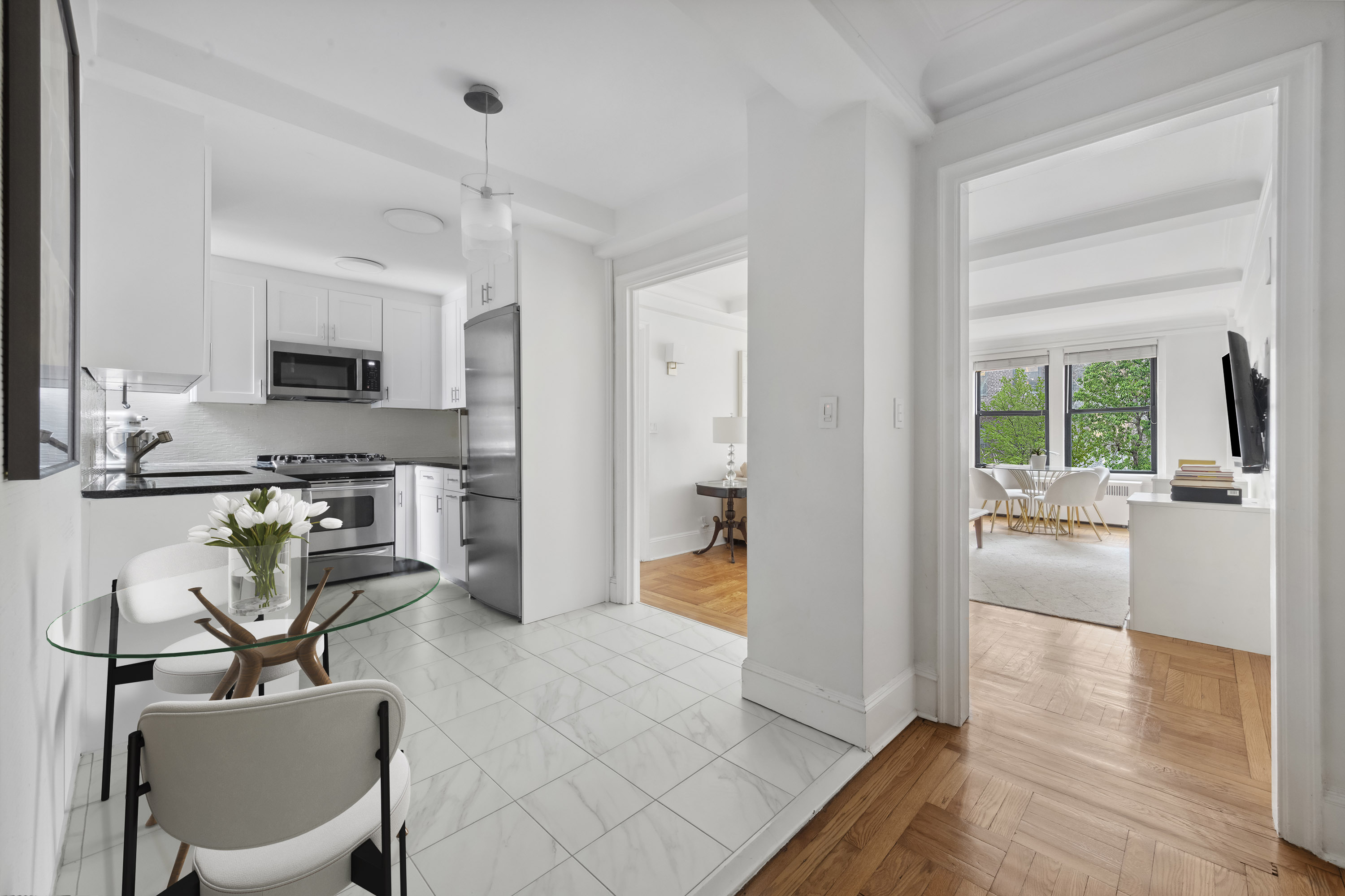 333 East 53rd Street, Unit 3KL Manhattan, NY 10022 - Photo 3 of 10 a view of a living room and a livingroom with furniture wooden floor a chandelier