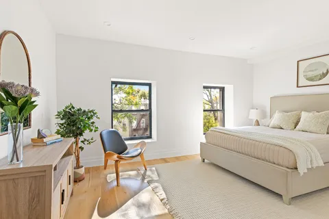 a living room with a bed furniture and a window