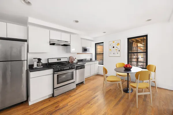 a bedroom with a large bed couch and a window