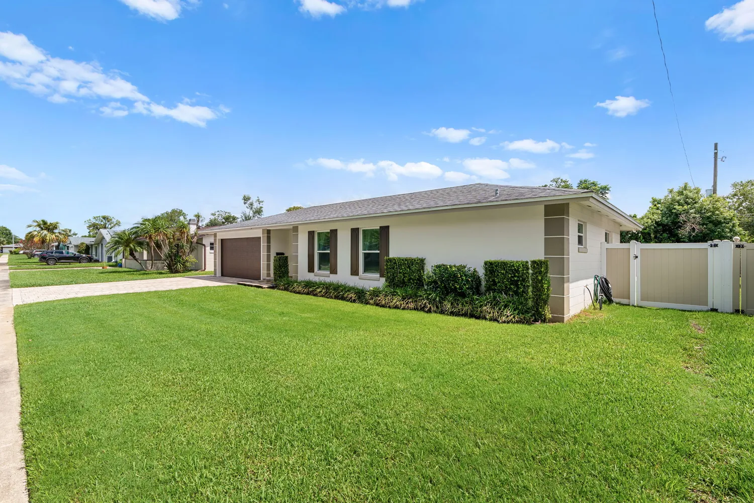 a yellow house with garden in front of it
