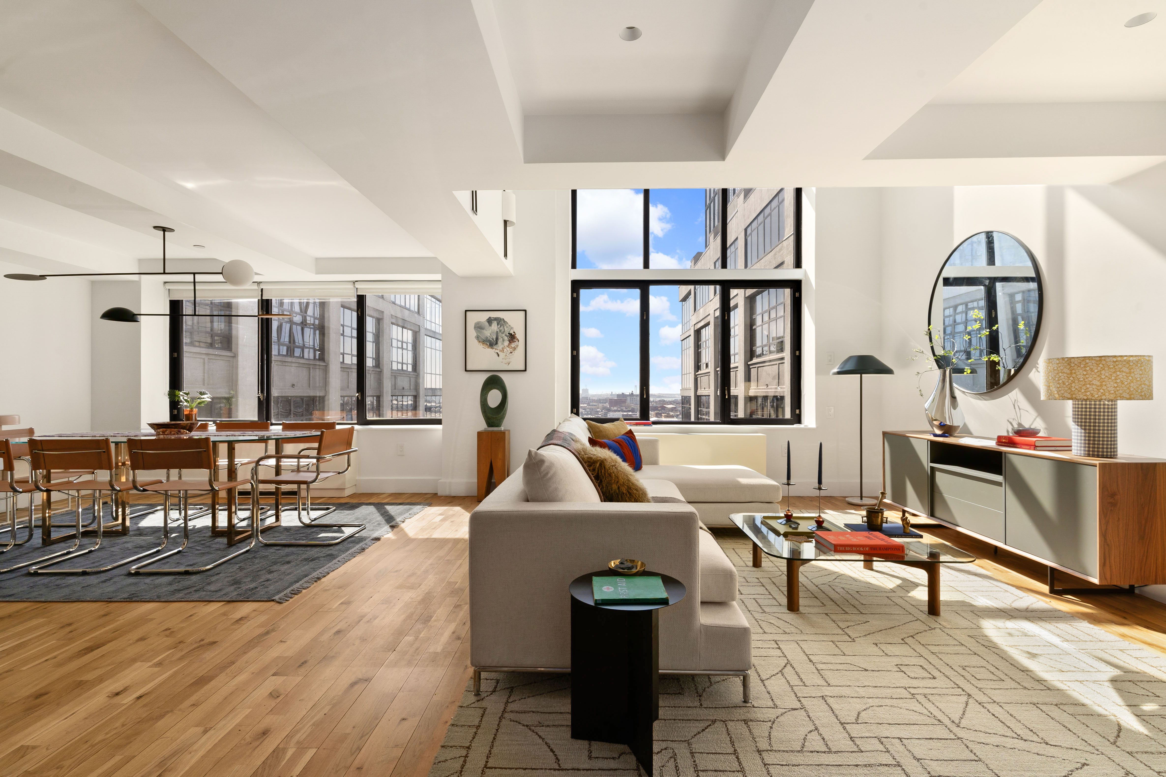 a living room with furniture a rug and a large window