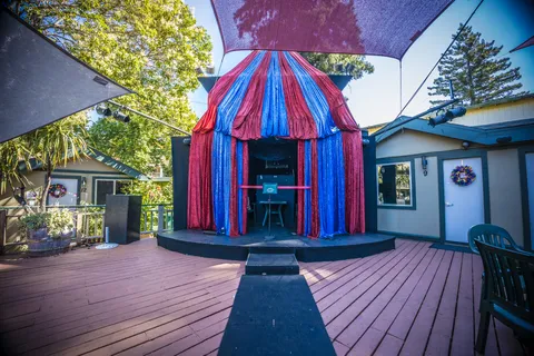 a dining room with furniture a rug and a chandelier