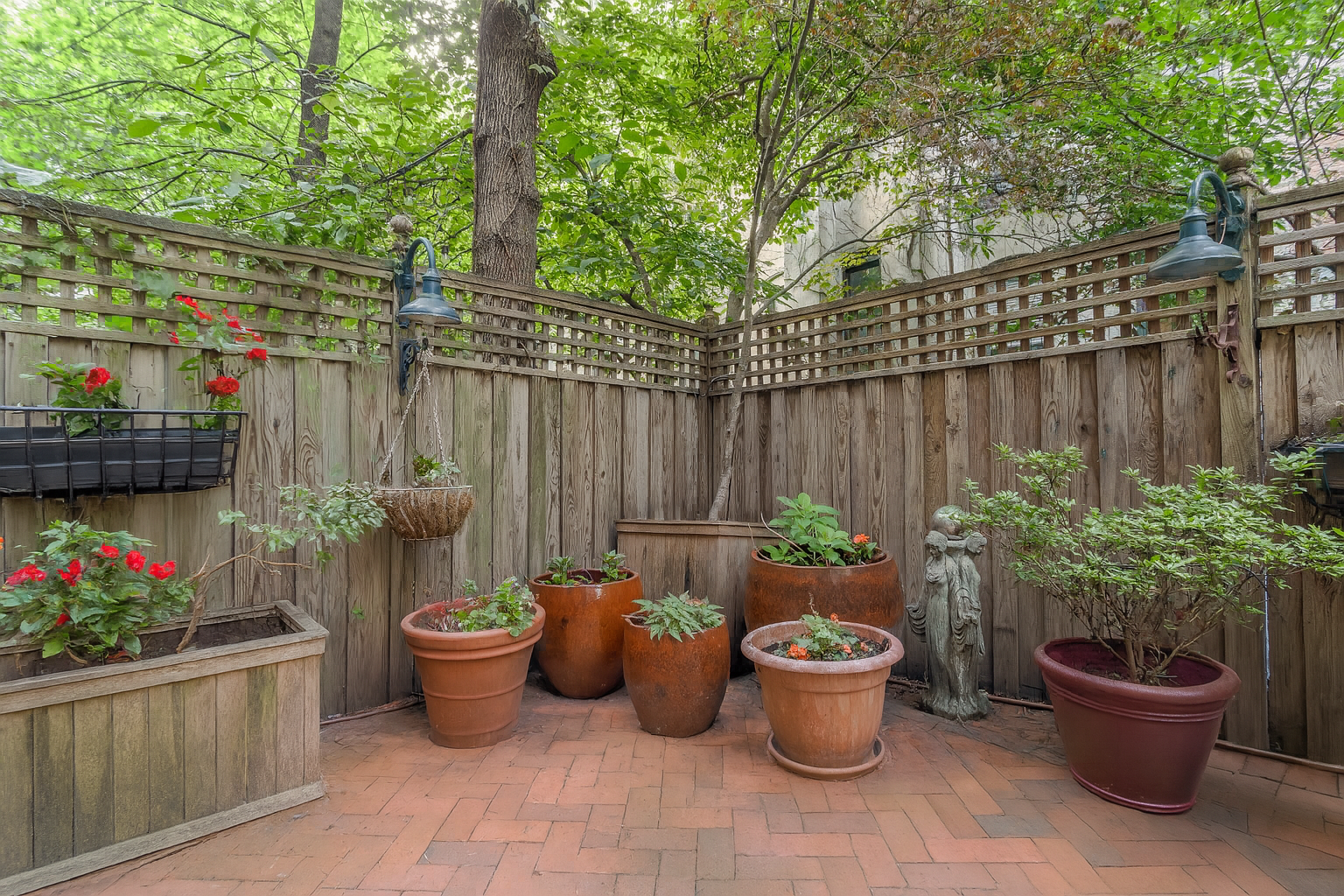 517 East 87th Street, Unit 1 Manhattan, NY 10128 - Photo 16 of 17 a view of a backyard with patio and potted plants