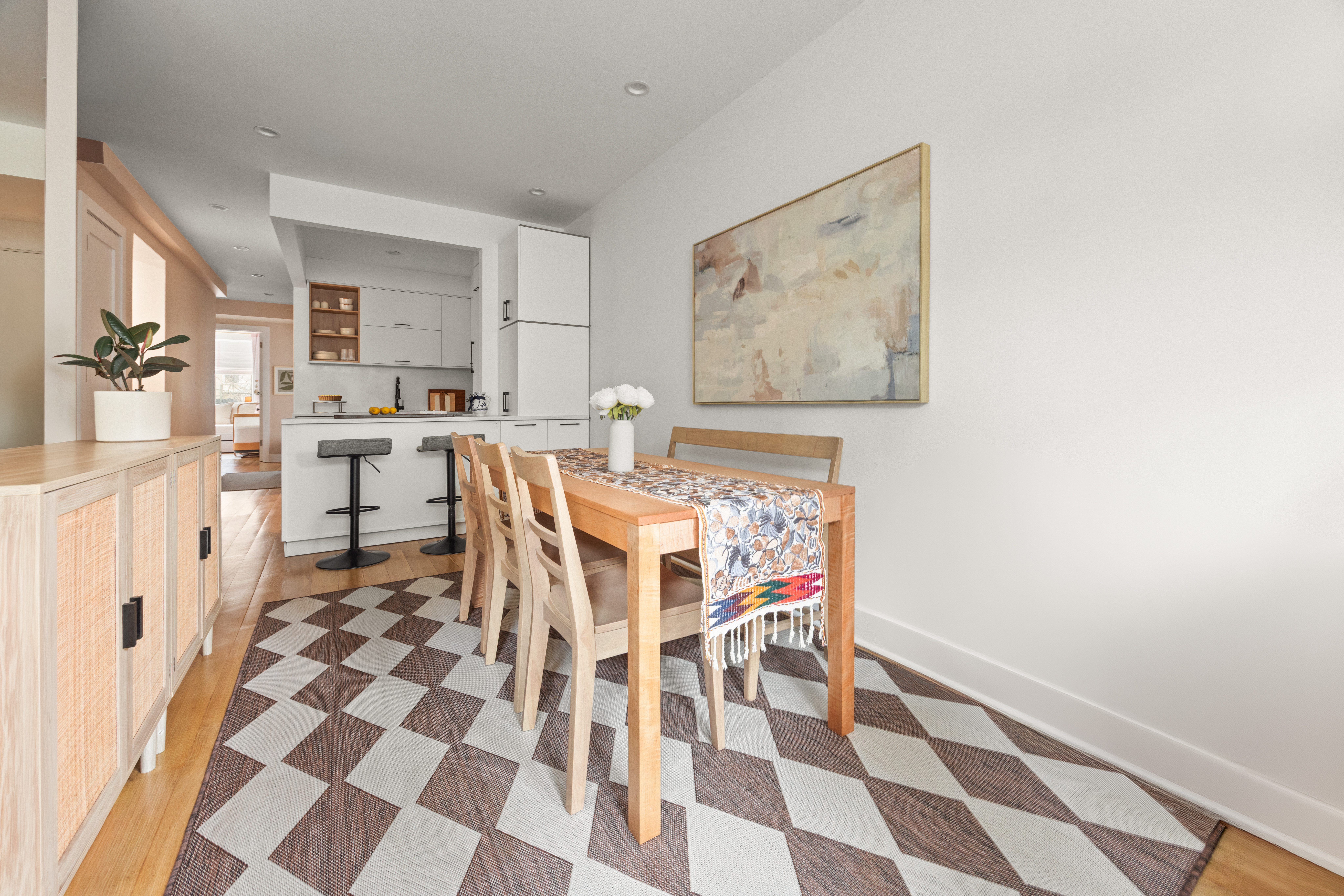 473 Bainbridge Street, Unit 1 Brooklyn, NY 11233 - Photo 3 of 15 a living room with a black white checkered floor with a dining table and chair