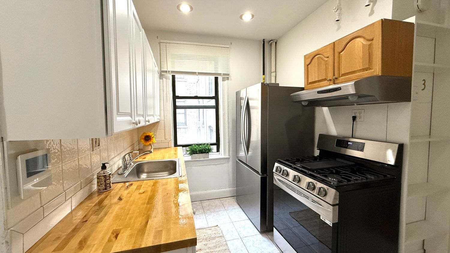 a kitchen with stainless steel appliances granite countertop a stove a sink and a refrigerator