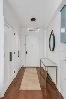 a view of a room with wooden floor and white walls