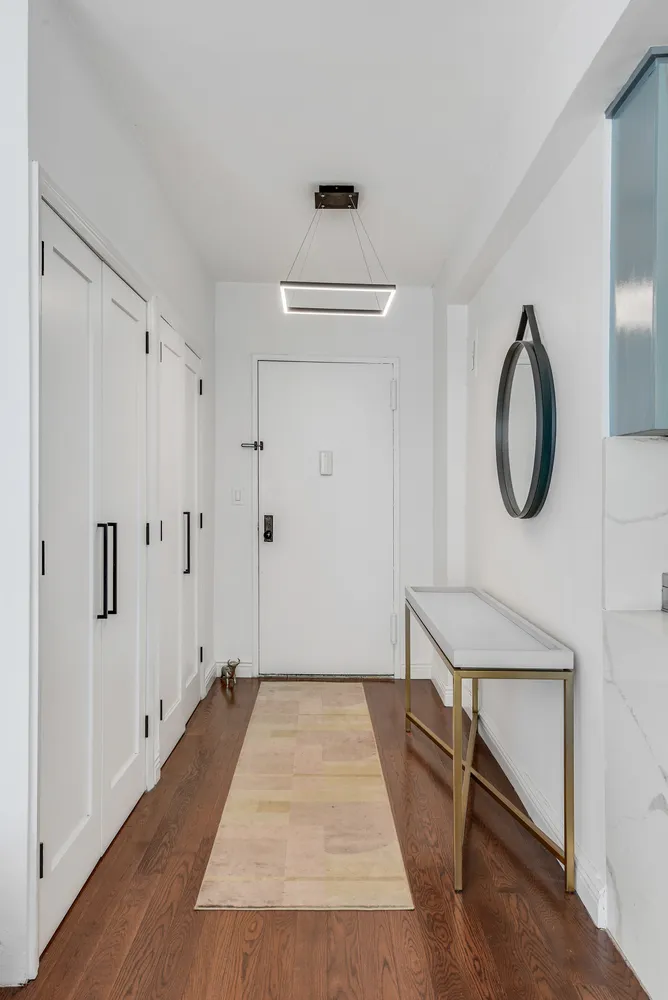 a view of a room with wooden floor and white walls
