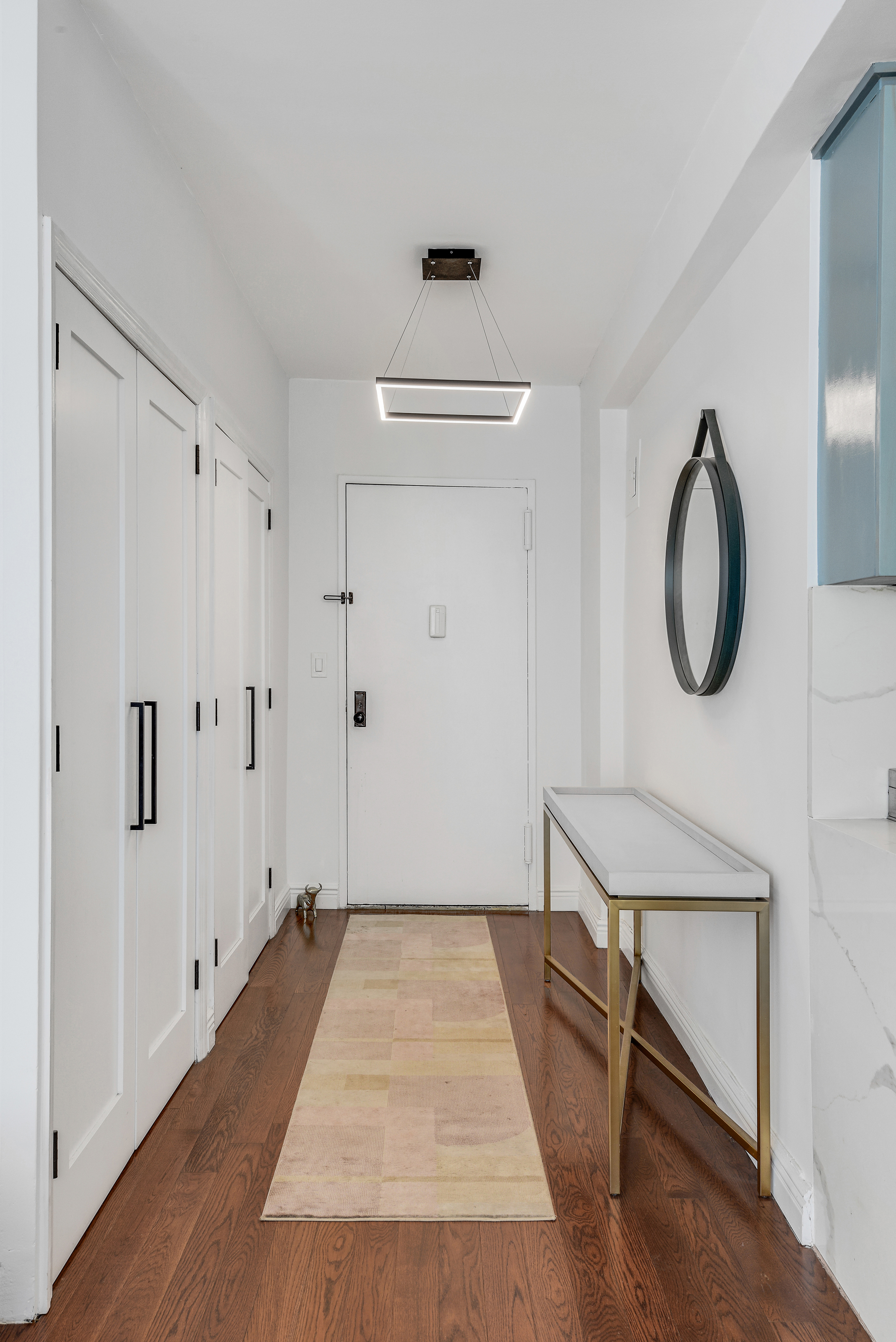 305 East 24th Street, Unit PHL Manhattan, NY 10010 - Photo 7 of 10 a view of a room with wooden floor and white walls