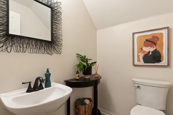 a bathroom with a toilet a sink and mirror