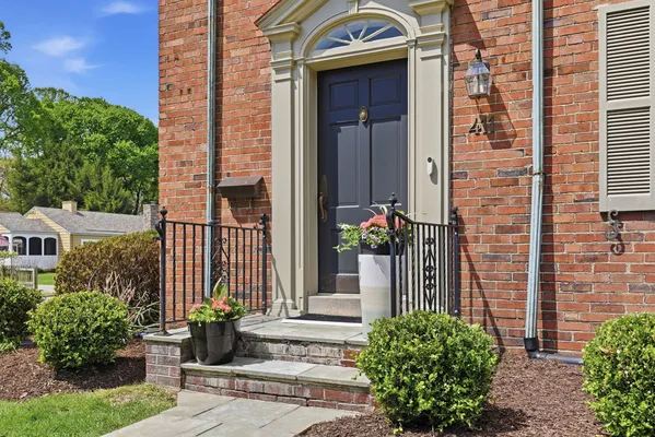 a front view of a house with a garden