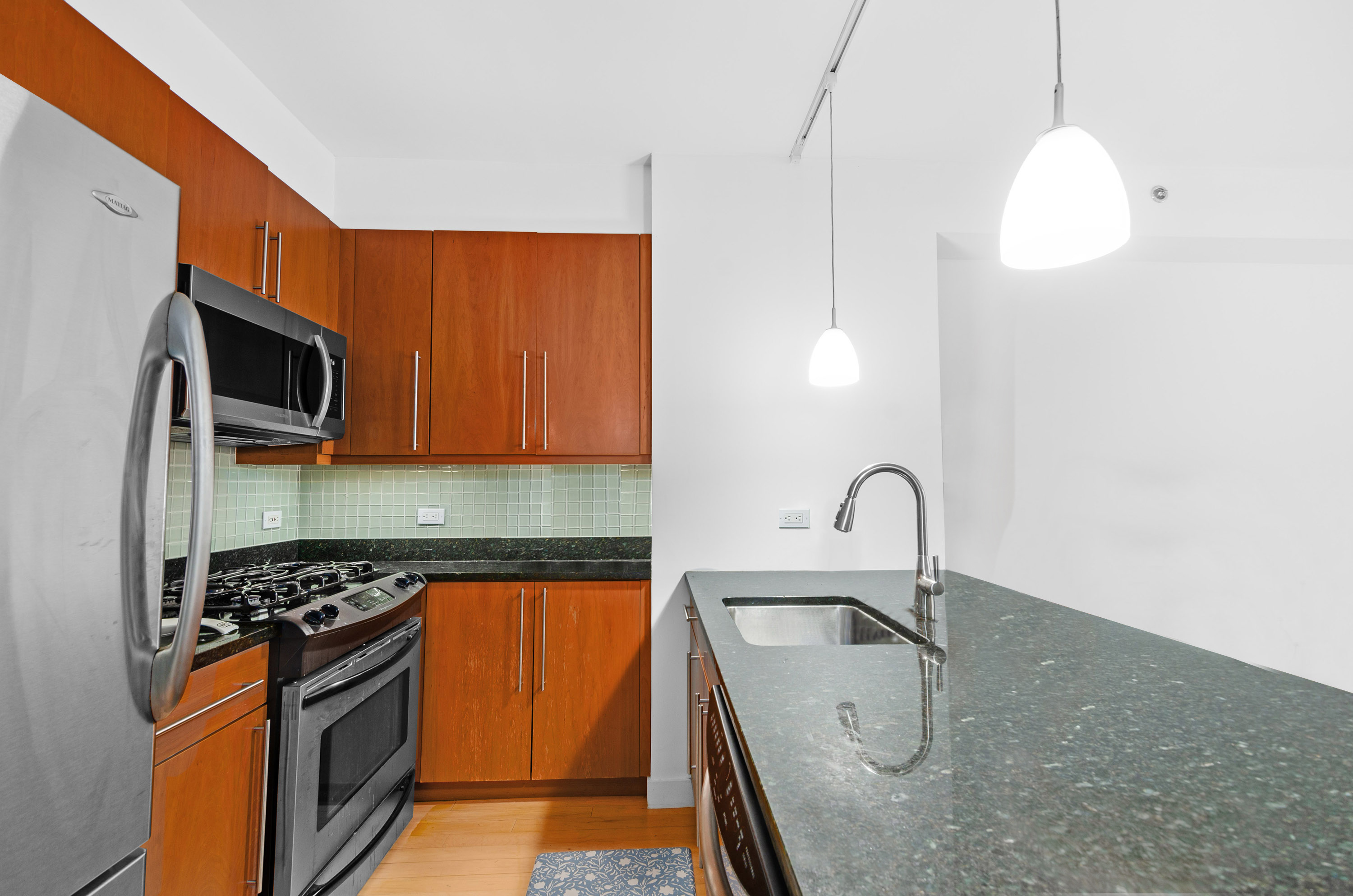 242 East 25th Street, Unit 5B Manhattan, NY 10010 - Photo 8 of 12 a kitchen with a sink stove and microwave