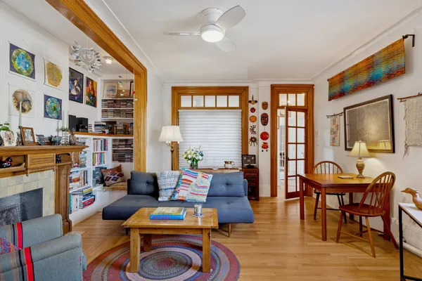a living room with furniture a flat screen tv and a floor to ceiling window