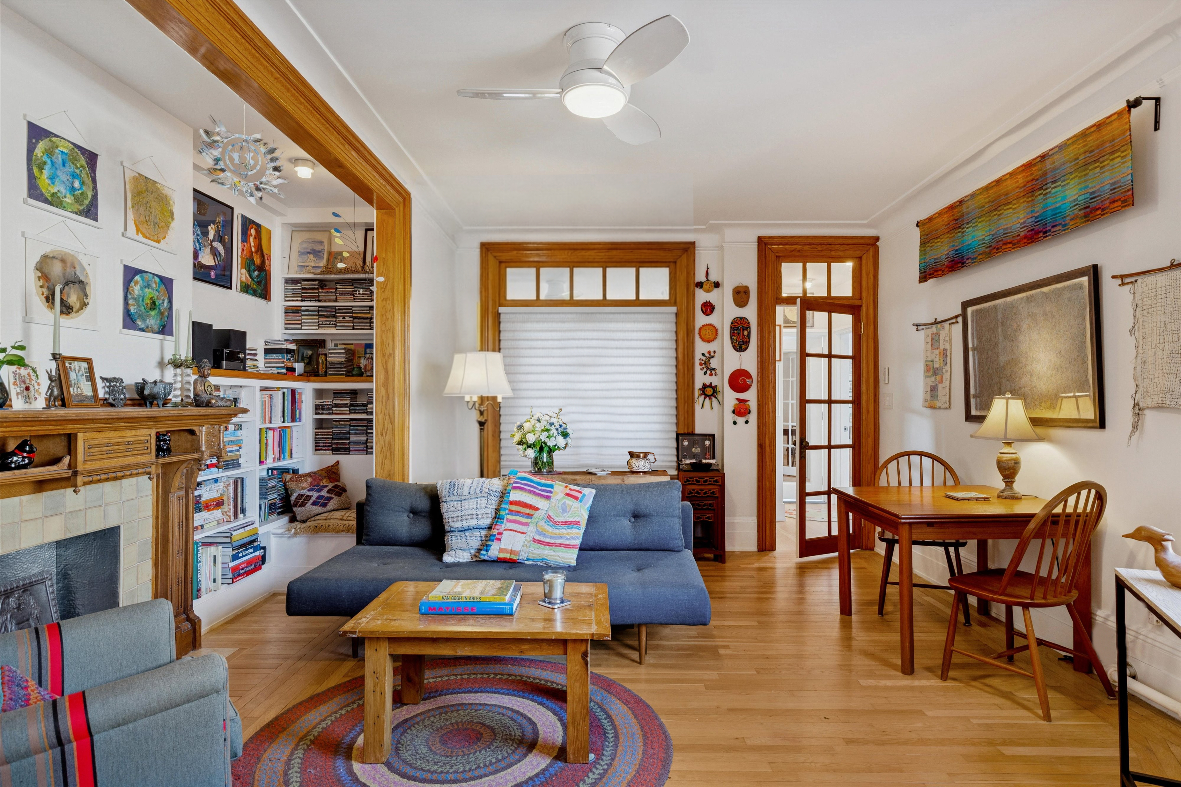 a living room with furniture a flat screen tv and a floor to ceiling window