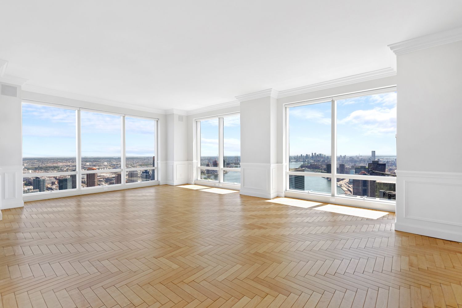 845 United Nations Plaza, Unit 63B Manhattan, NY 10017 - Photo 4 of 14 a view of an empty room with wooden floor and a window