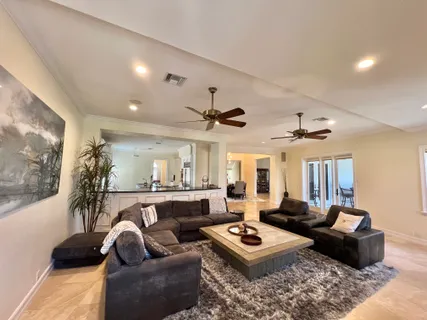 a living room with furniture a rug and a chandelier