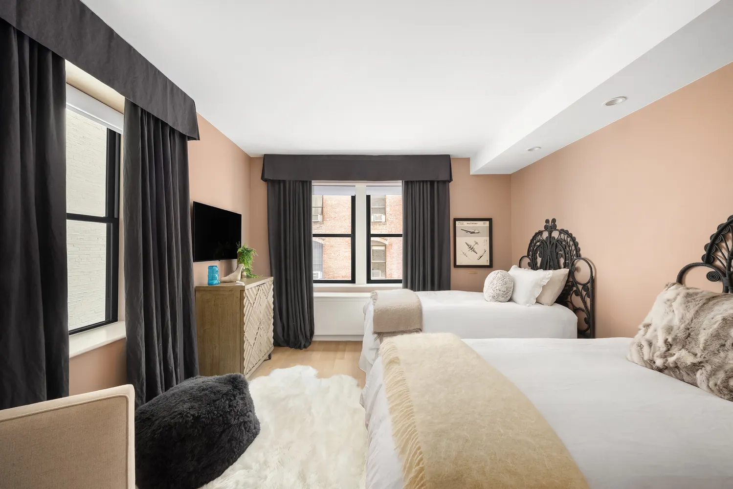 a spacious bedroom with a bed and flat screen tv