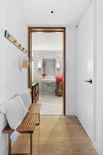 a living room with furniture and a mirror