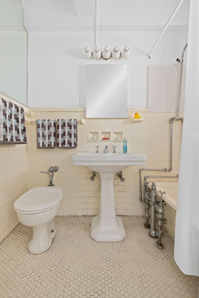 a bathroom with a sink a toilet and mirror
