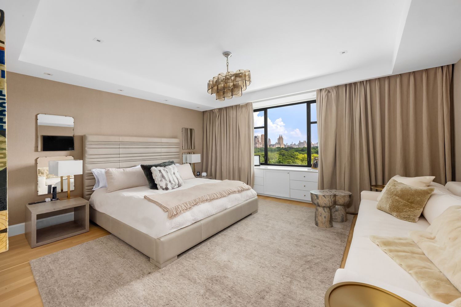 a bedroom with a potted plant and a flat screen tv