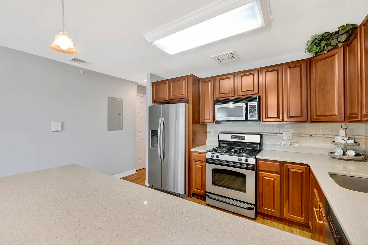 a kitchen with stainless steel appliances a stove a refrigerator and a sink