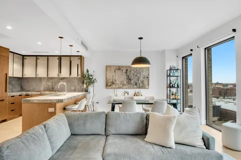 a living room with furniture and a chandelier