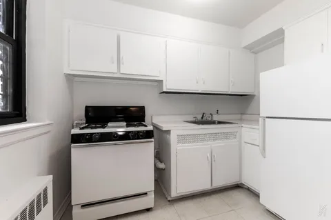 a kitchen with cabinets appliances and a sink