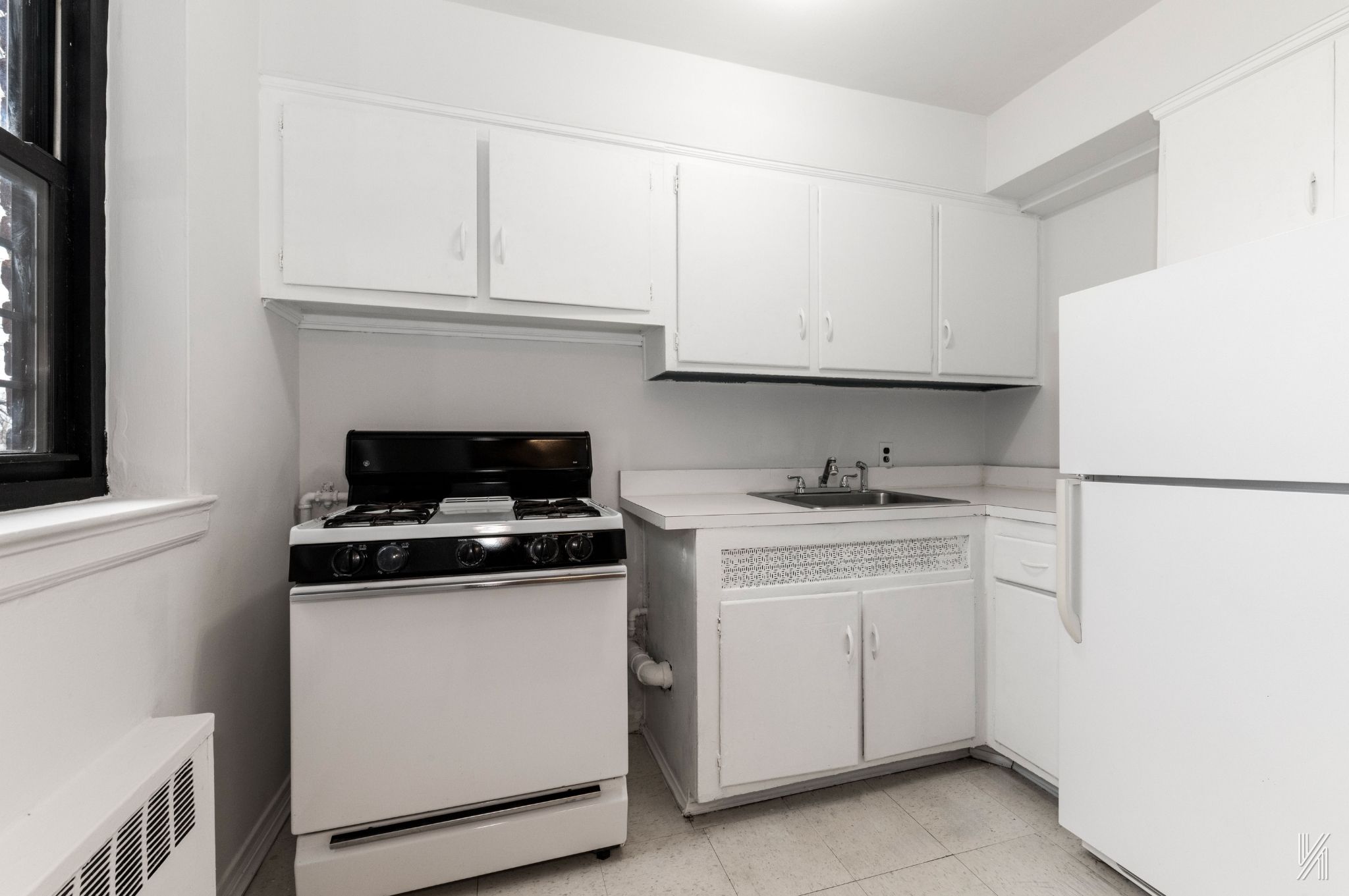 22-60 79th Street, Unit 3E Queens, NY 11370 - Photo 13 of 17 a kitchen with cabinets appliances and a sink