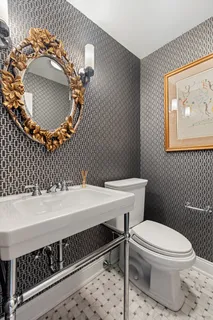 a bathroom with a sink a toilet and mirror