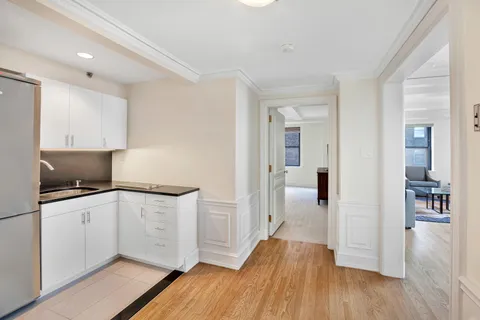 a kitchen with granite countertop a sink and a stove top oven