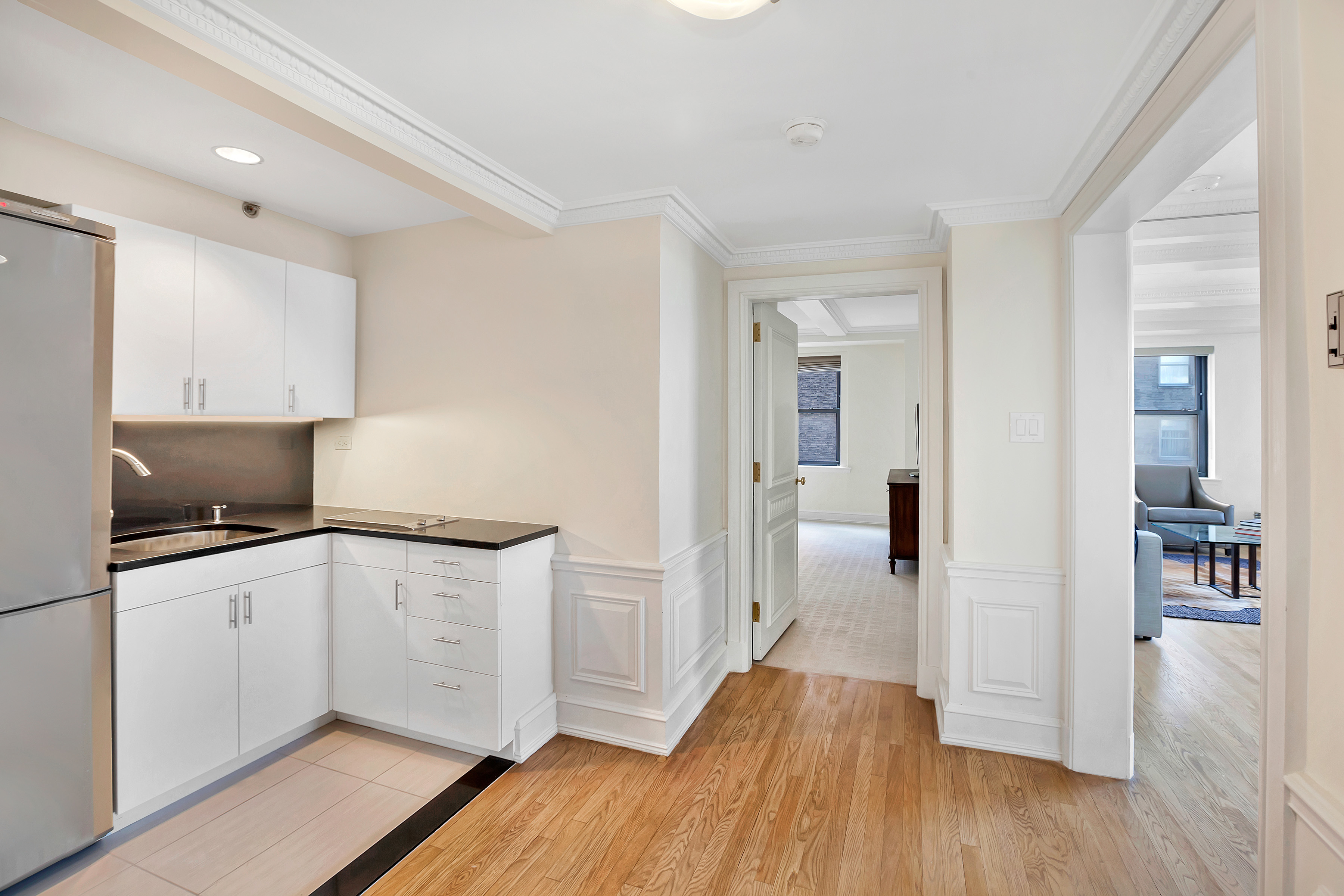160 Central Park South, Unit 2307 Manhattan, NY 10019 - Photo 5 of 14 a kitchen with granite countertop a sink and a stove top oven