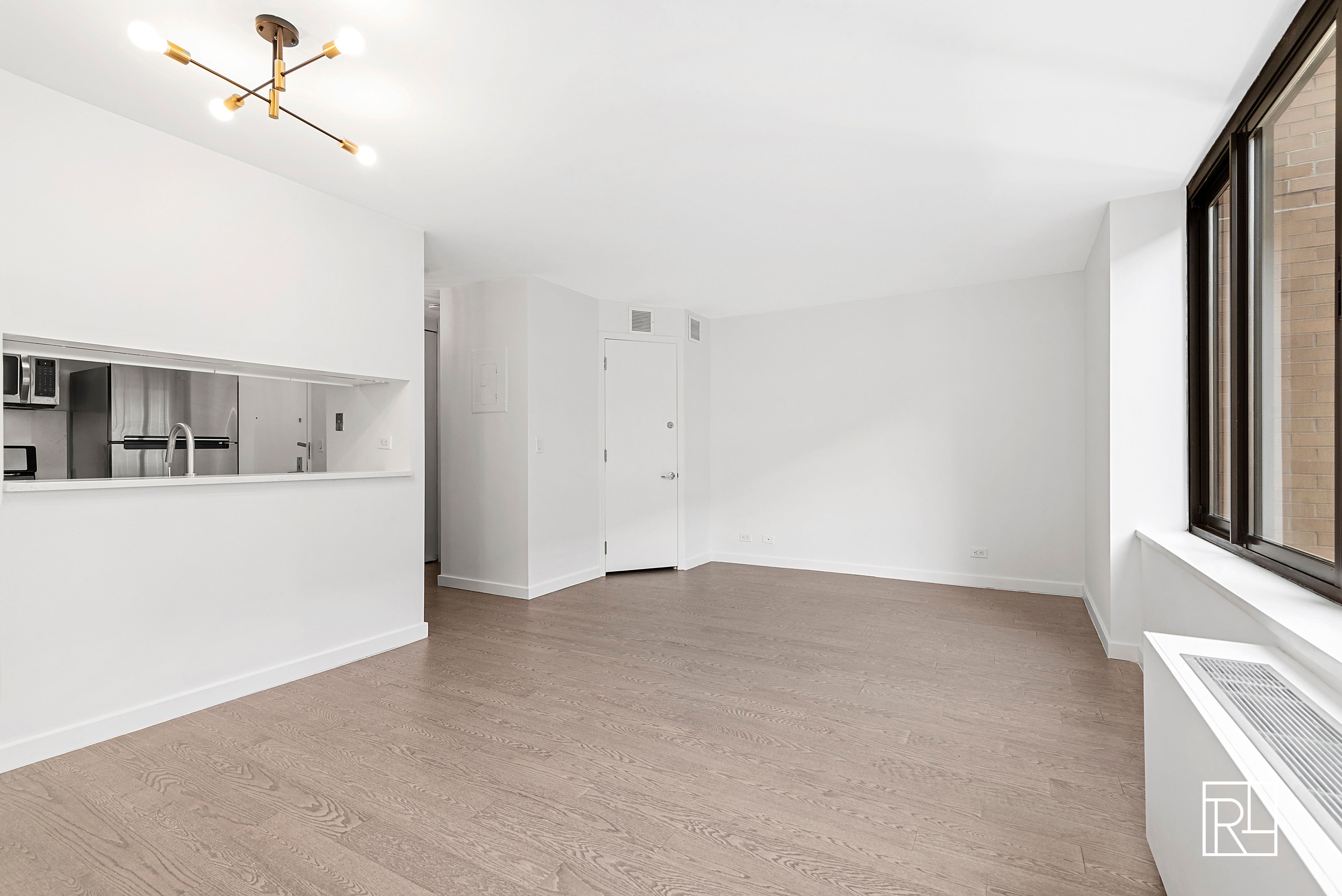 161 West 61st Street, Unit 12D Manhattan, NY 10023 - Photo 2 of 15 a view of a kitchen with a sink and a window