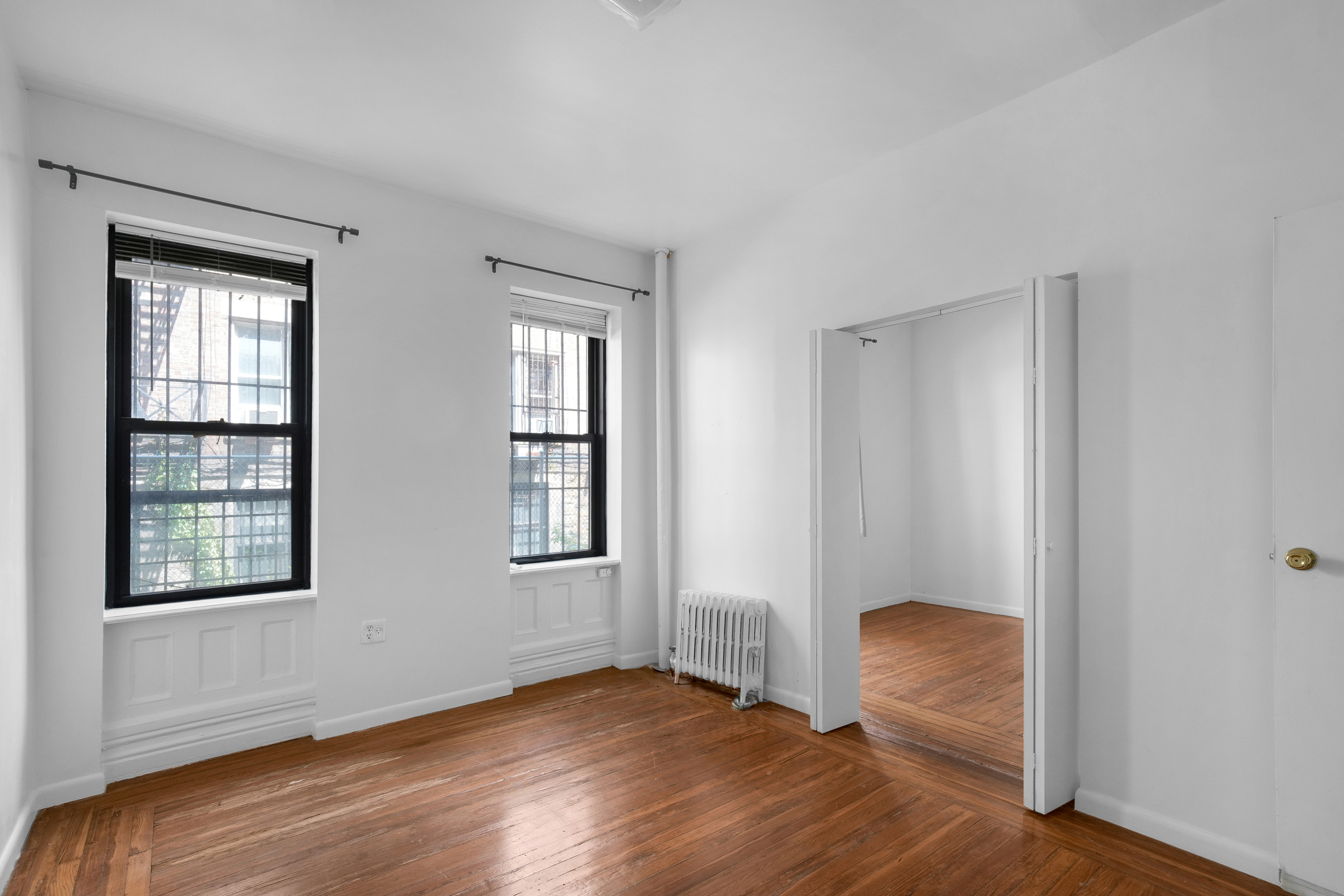 a view of room with window and wooden floor