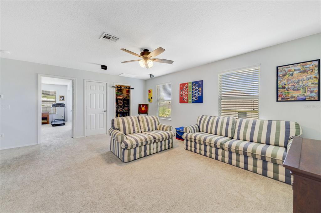 352 Giovani Boulevard Clermont, FL 34715 - Photo 18 of 46 a living room with furniture ceiling fan and a window