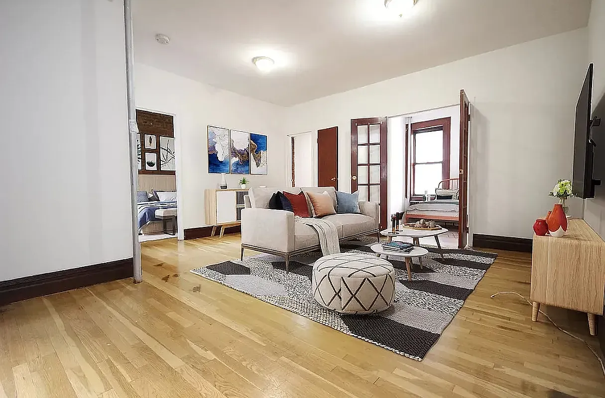 24 East 97th Street, Unit 13 Manhattan, NY 10128 - Photo 2 of 6 a bedroom with furniture and a flat screen tv