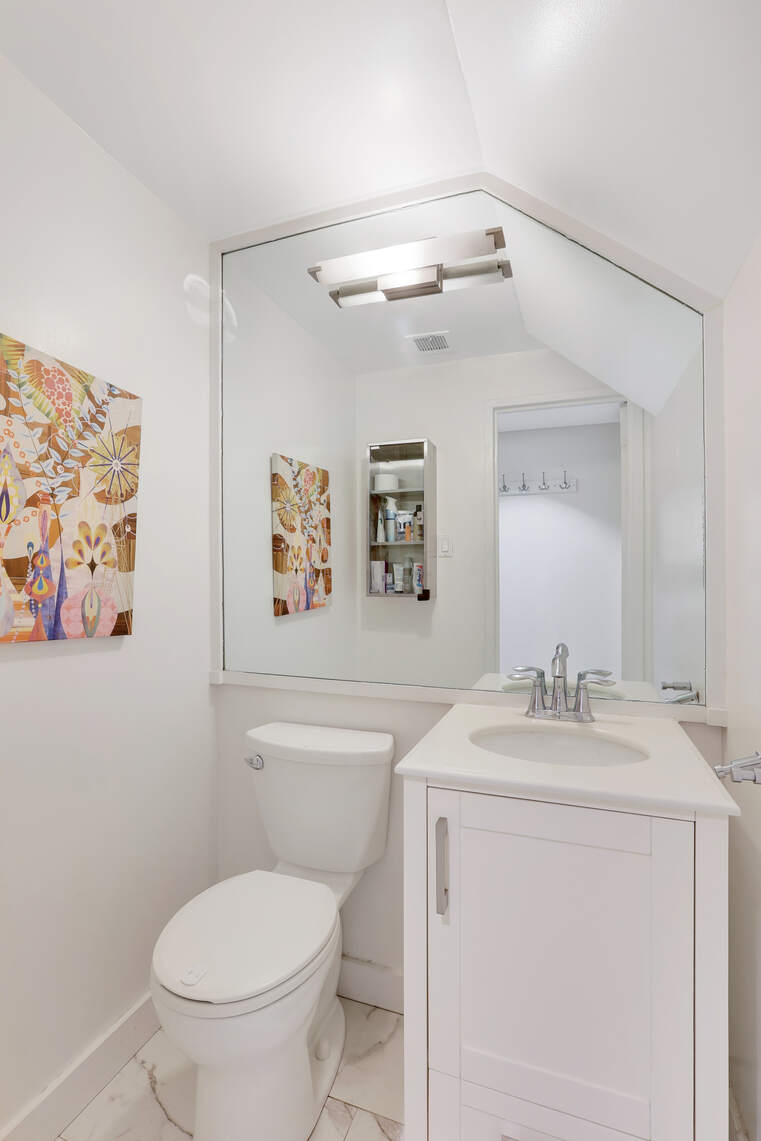 344 West 23rd Street, Unit 1E Manhattan, NY 10011 - Photo 16 of 19 a bathroom with a toilet sink and mirror