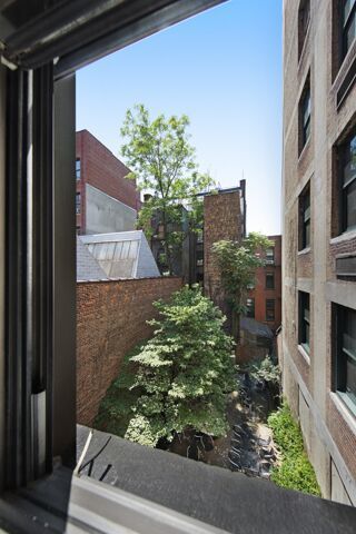 212 West 14th Street, Unit 3B Manhattan, NY 10011 - Photo 6 of 6 a view of a house with a flower garden