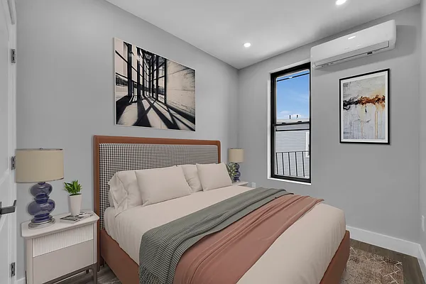 30 Marconi Place, Unit 2 Brooklyn, NY 11233 - Photo 8 of 11 a bedroom with a bed and painting on the wall