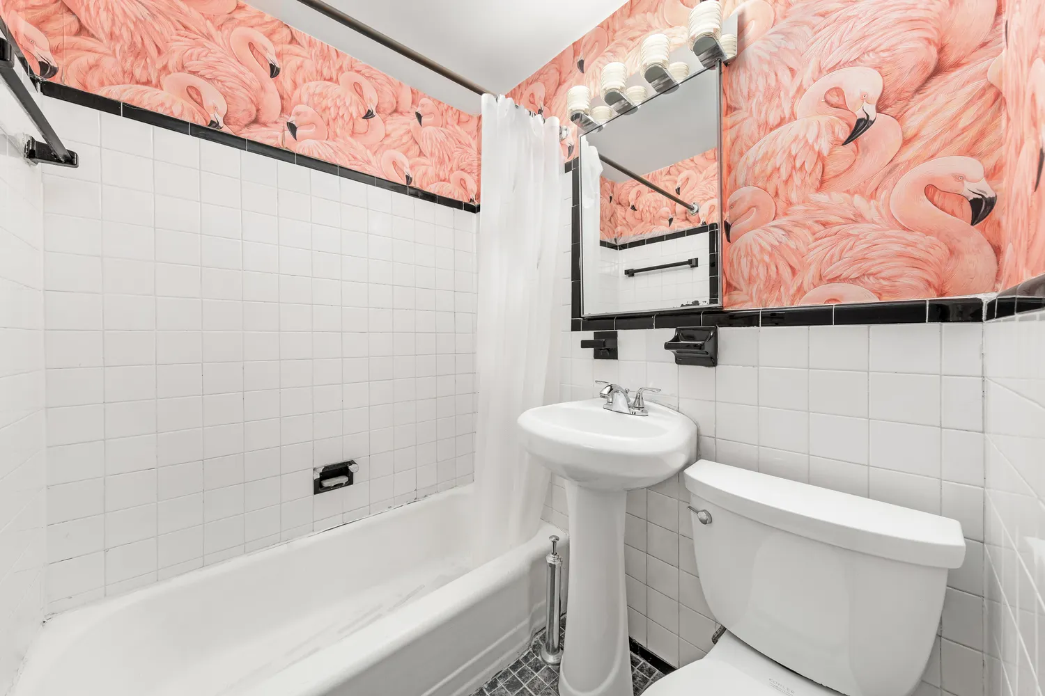 a bathroom with a sink and mirror with toilet