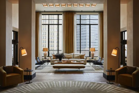 a living room with furniture and large windows