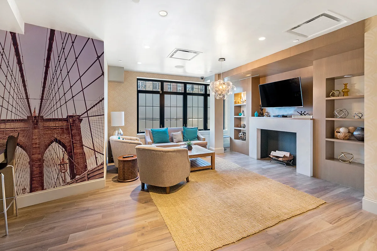 42 Maspeth Avenue, Unit 1B Brooklyn, NY 11211 - Photo 8 of 12 a living room with furniture a flat screen tv and a fireplace
