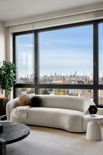 a living room with furniture and a floor to ceiling window